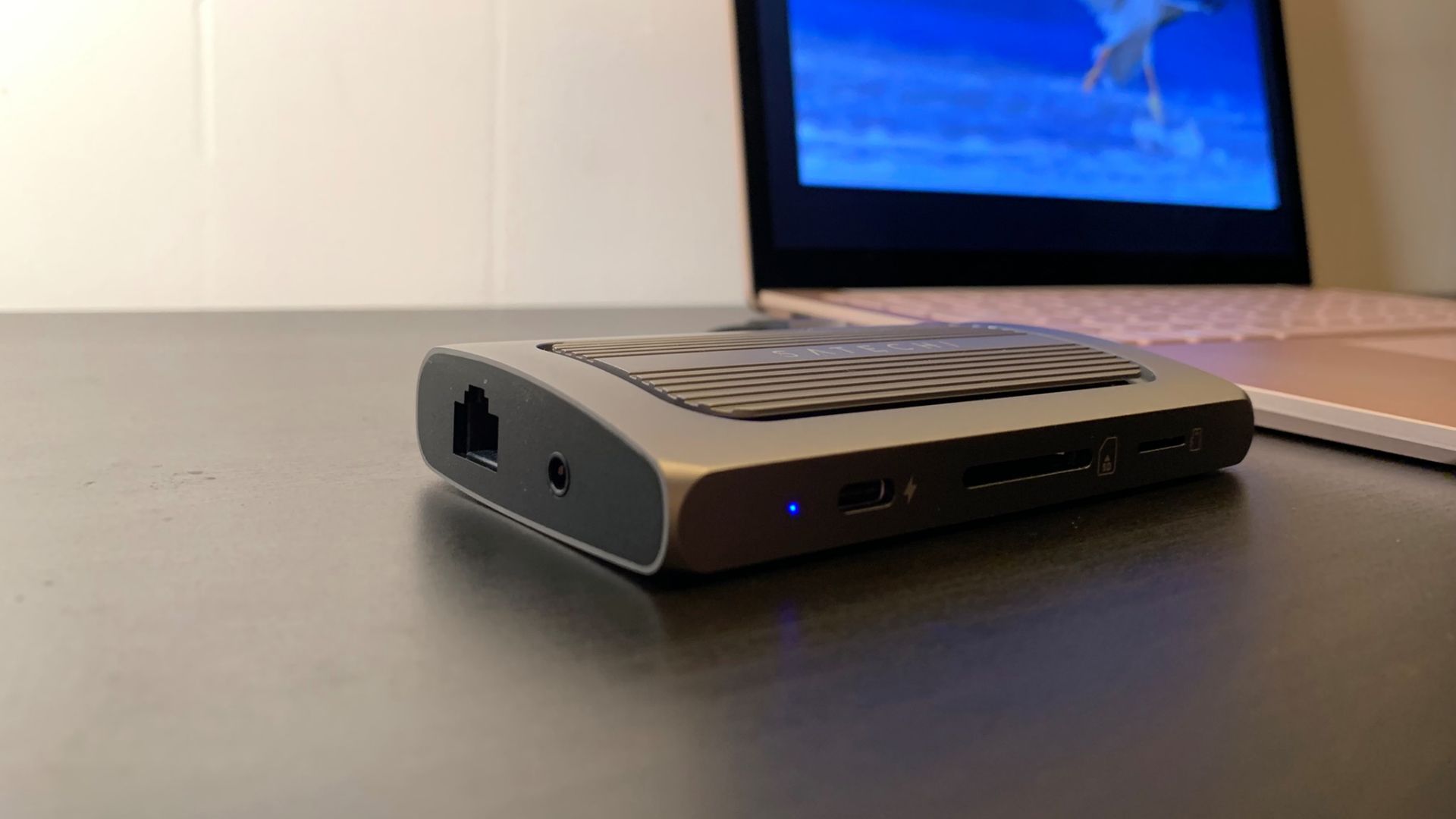 Satechi USB-4 Multiport Adapter with 8K HDMI attached to laptop on desk
