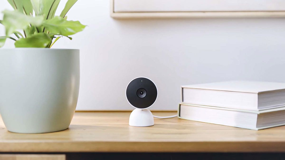 A Google Nest wired security camera sitting on a table in a home.