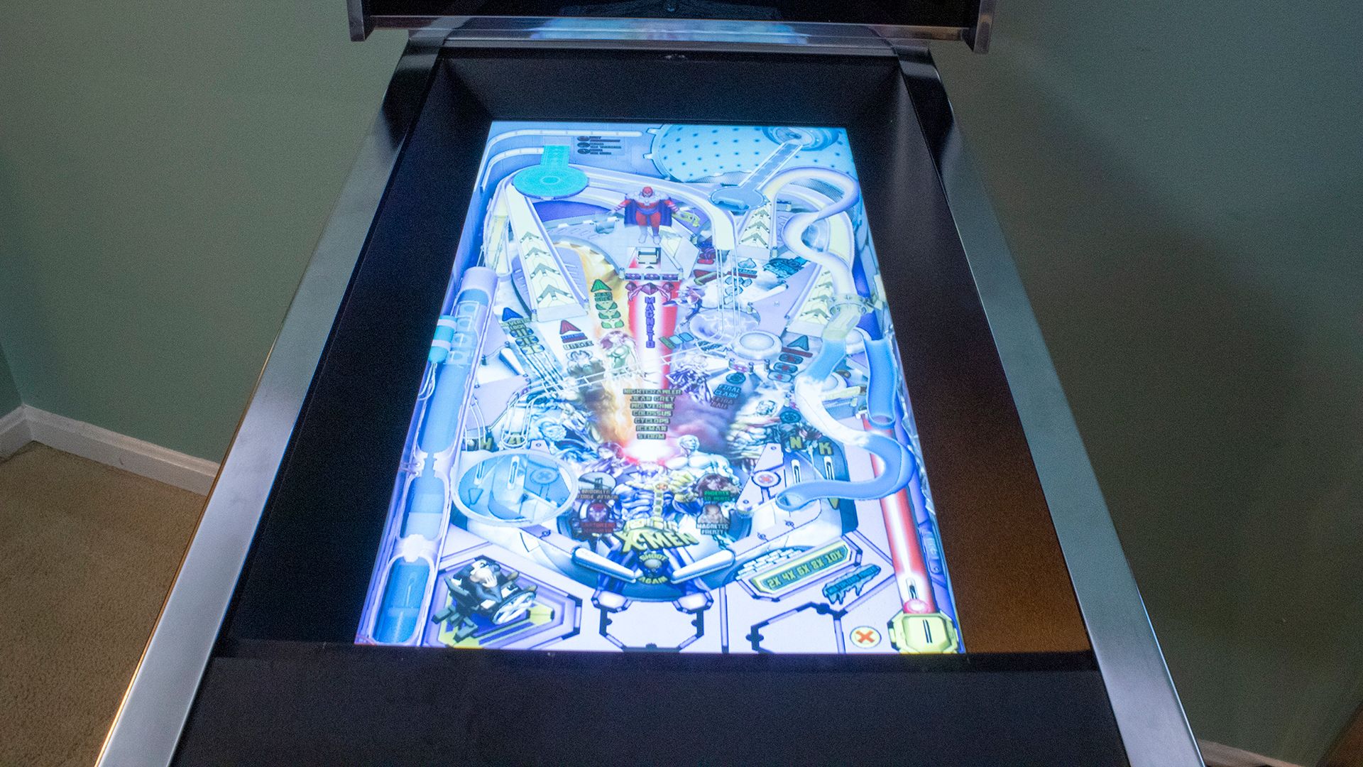 A closeup of a pinball screen with washed out colors.