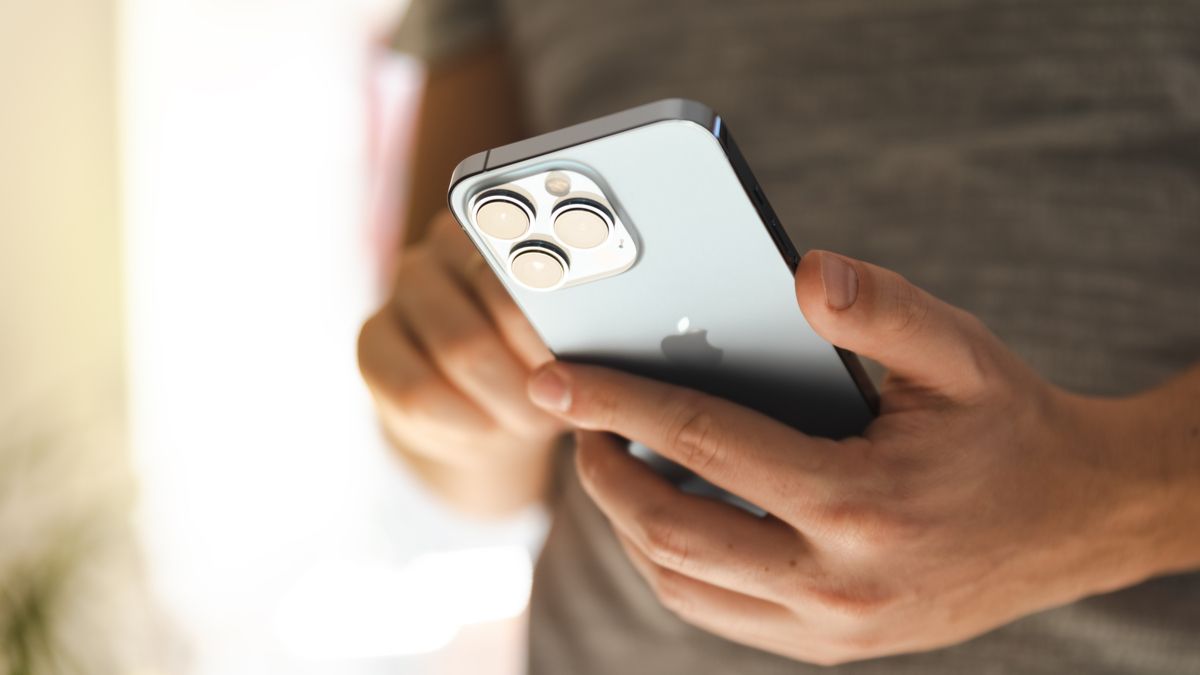 Closeup of an iPhone 13 Pro in a person's hands.