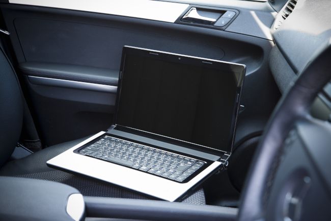 A laptop in a car passenger seat.