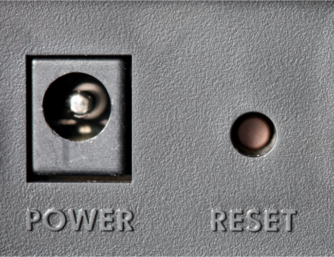 An inset Reset button next to a power connector.
