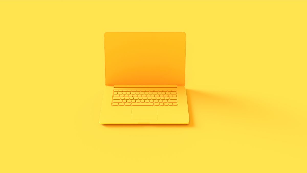 A yellow laptop on a yellow background.