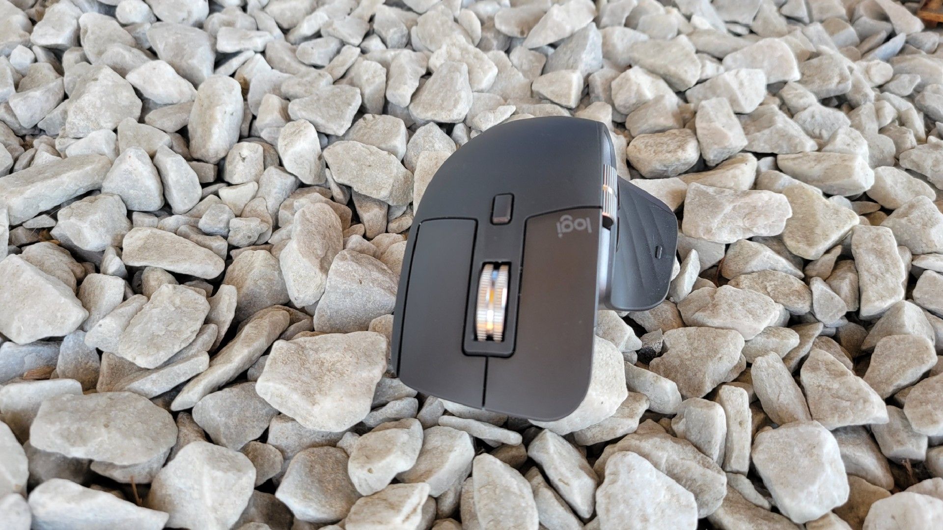 The Logitech MS Master 3S on a bed of gravel