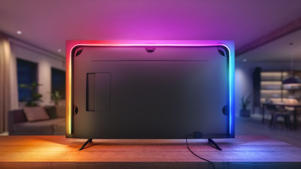 The back view of a TV outfited with a Hue lightstrip and Hue sync box.