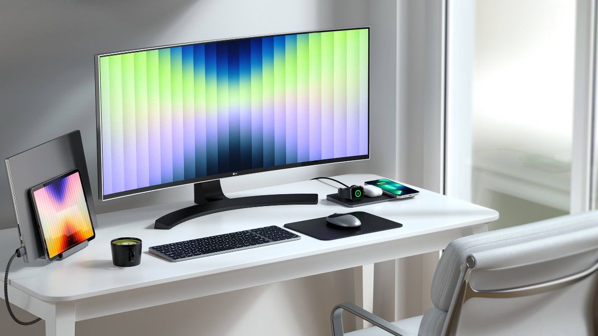 Desktop with Satechi keyboard, laptop holder, wireless charger, mouse pad, and an LG computer monitor