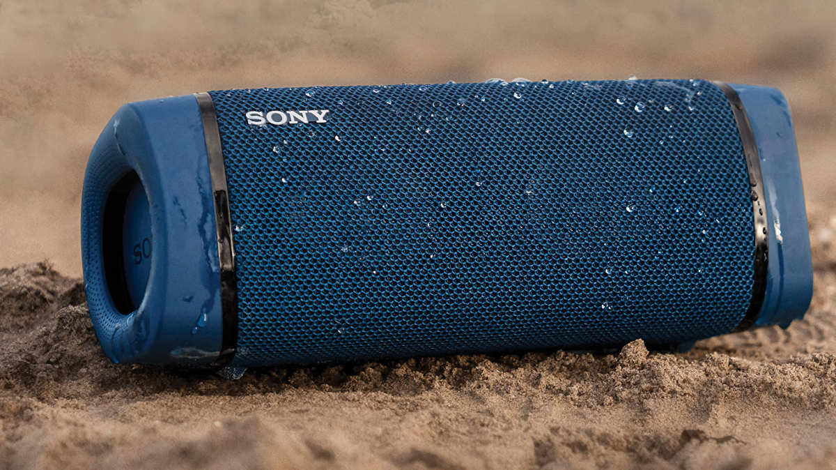 Sony SRS-XB33 Bluetooth Speaker sitting on a sandy beach