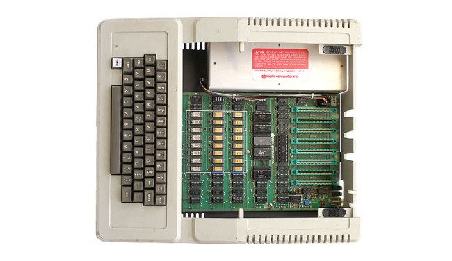 The Apple II with its lid open, showing its internal expansion slots.