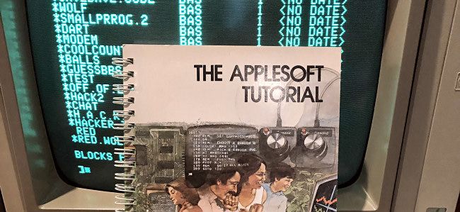 "The Applesoft Tutorial" book cover on an Apple II.