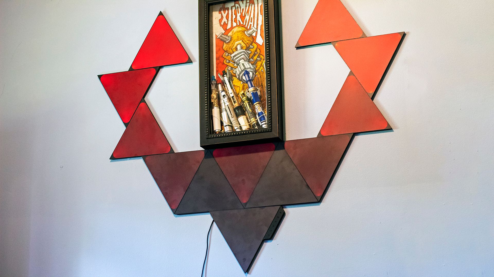 A set of black triangles turning red on a wall