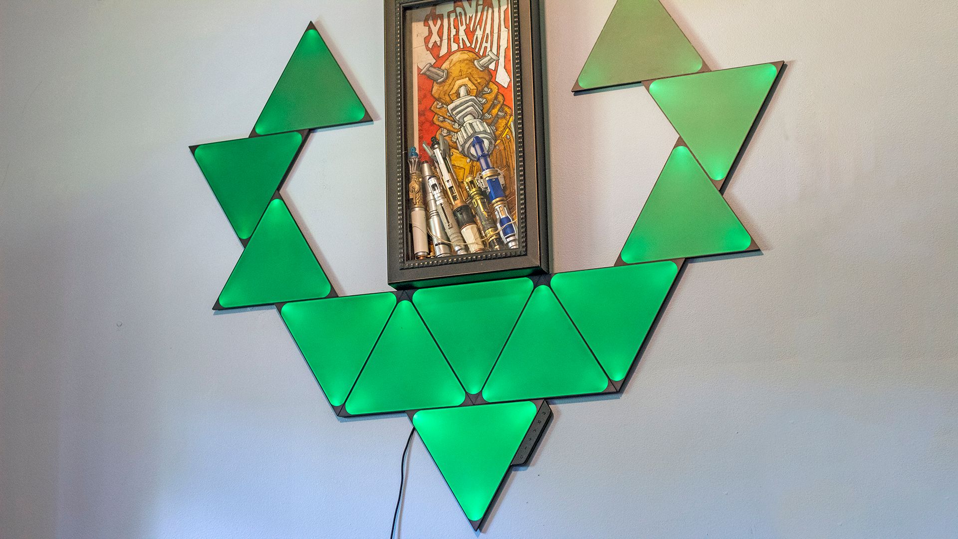 A set of triangles on the wall, glowing green