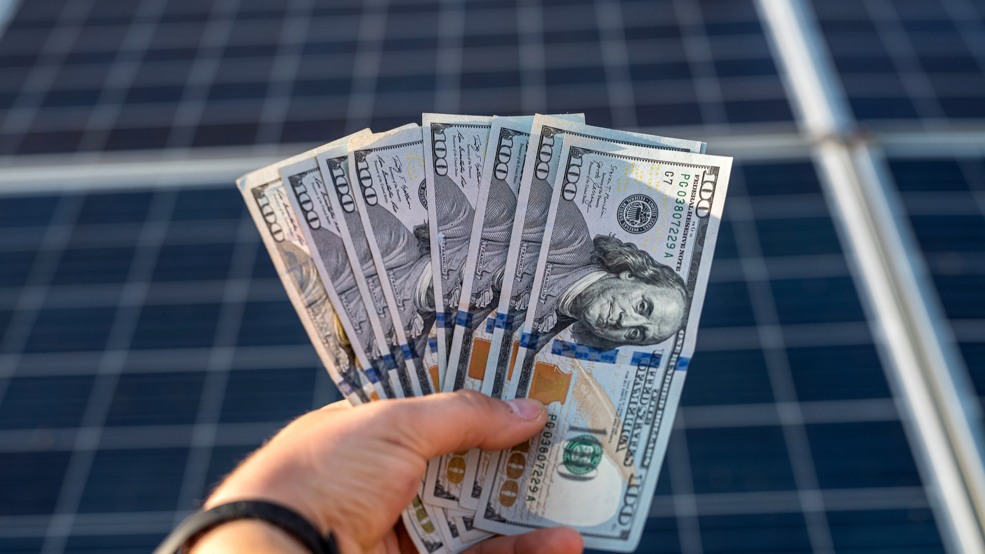 Solar panels and a pile of cash