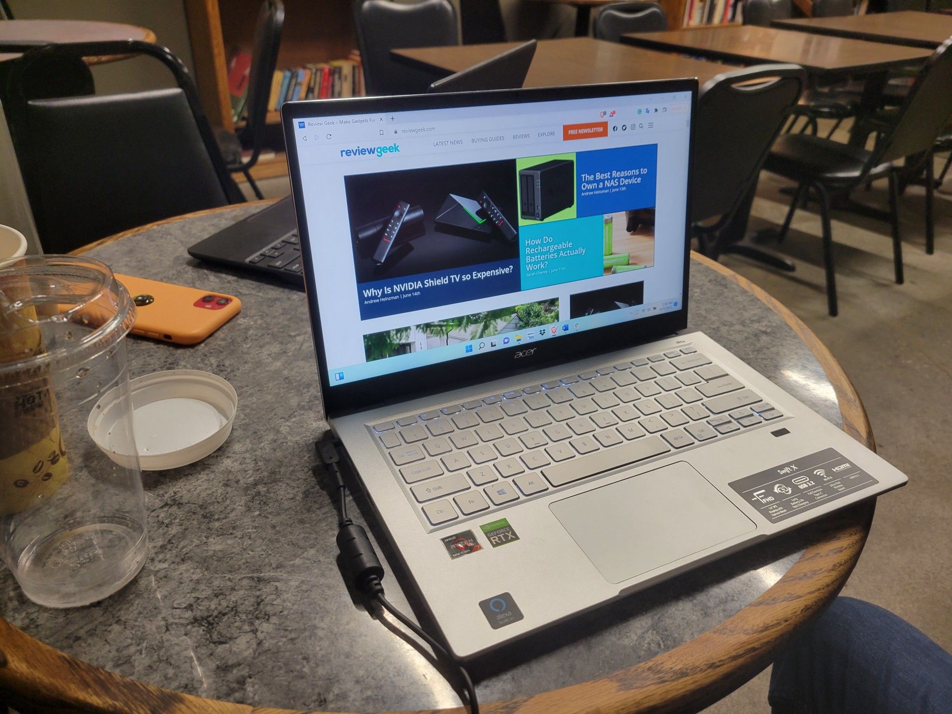 The Acer Swift X on a cafe desk