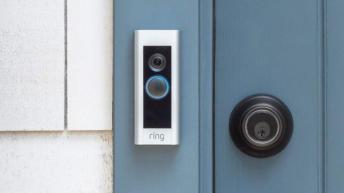 A Ring Pro doorbell installed next to a blue door.