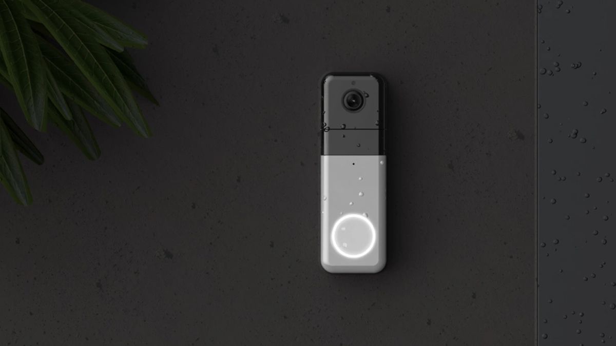 A Wyze Pro doorbell on a charcoal gray wall.
