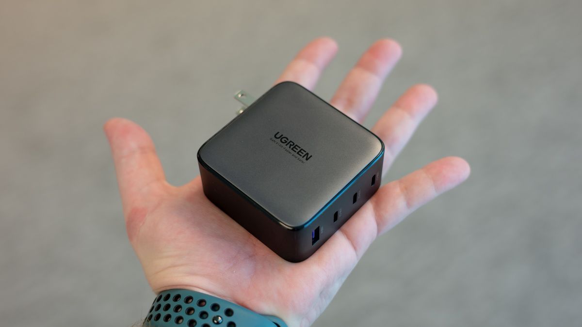 UGREEN Nexode 100W Charger sitting in a person's hand