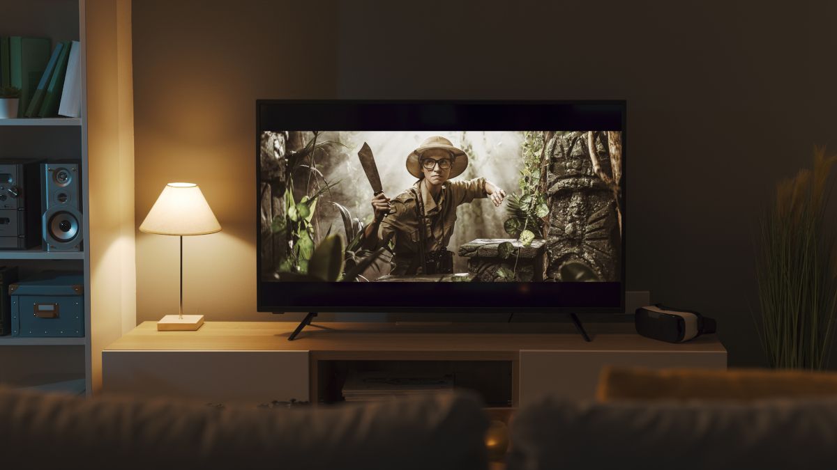 A TV in a living room with an adventure movie on display.