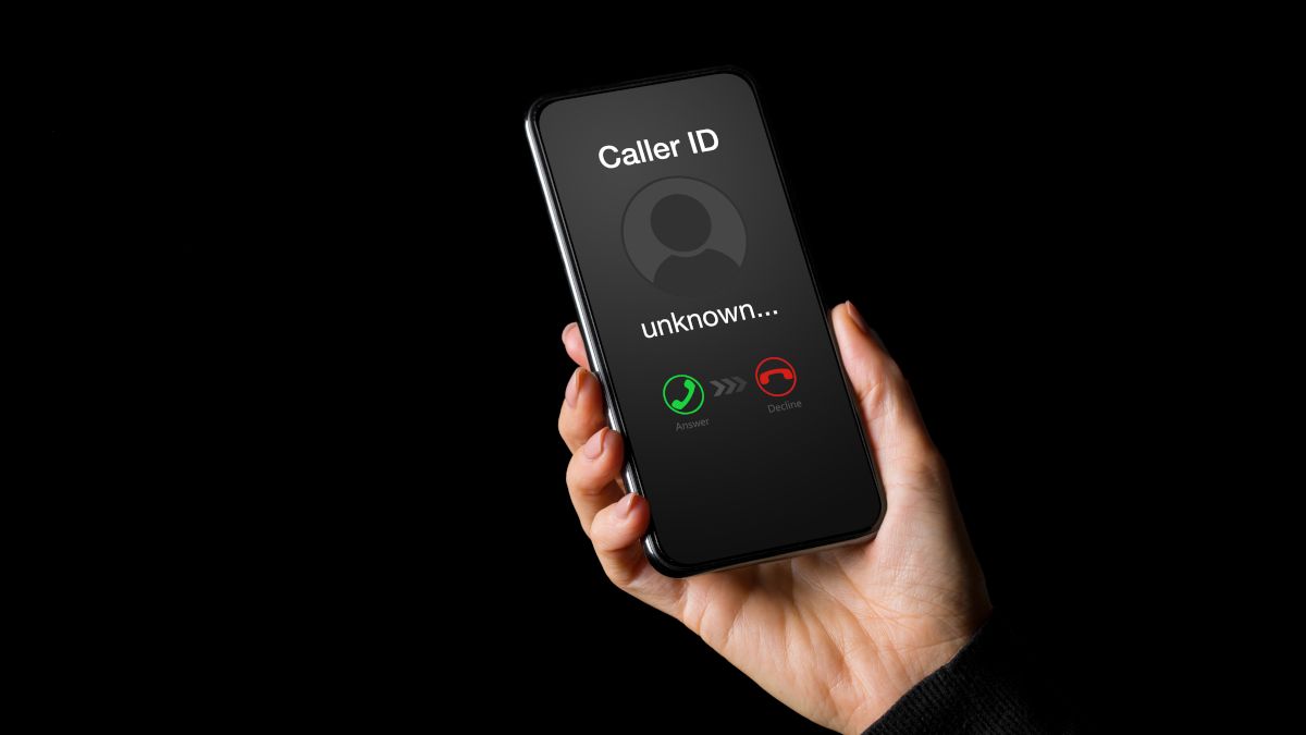 Closeup of a smartphone showing caller ID from an unknown number.