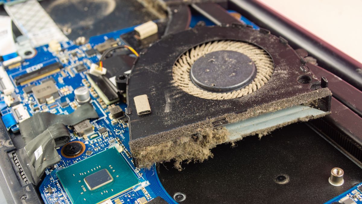 A dusty internal fan removed from a laptop.