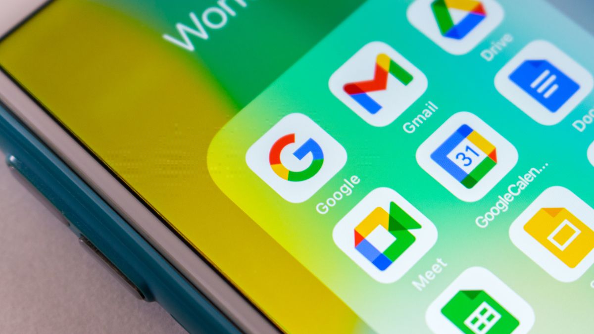 Closeup of an iPhone screen showing Google, Gmail, Google Meet, and Google Calendar app icons.