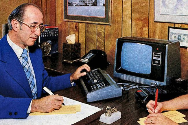 A man using a TRS-80 on a desk. Part of an advertisement for the TRS-80 Model I that appeared in November 1977 issue of Byte magazine.