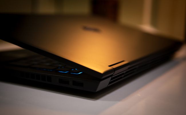 Closeup of the rear corner of a gaming laptop with the vents visible.