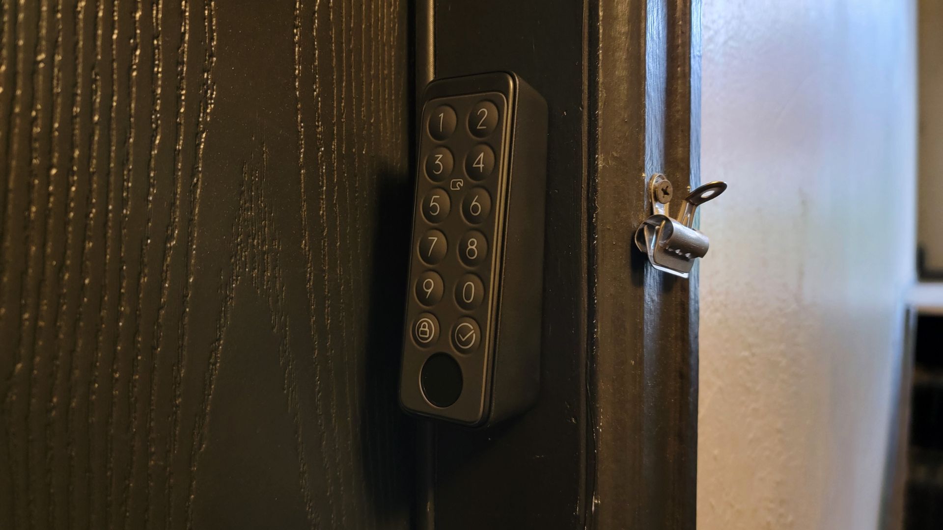 closeup of the switchbot touch keypad installed on external door frame