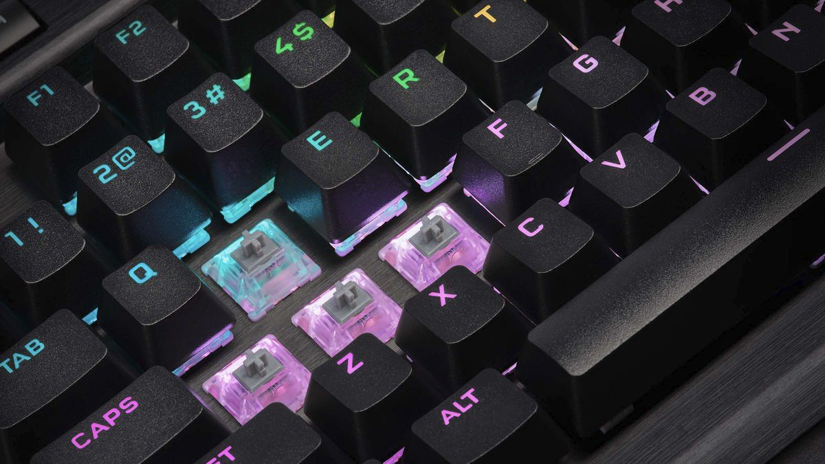 A Corsair keyboard with some of the keycaps removed, showing the stems of the Cherry MX switches.