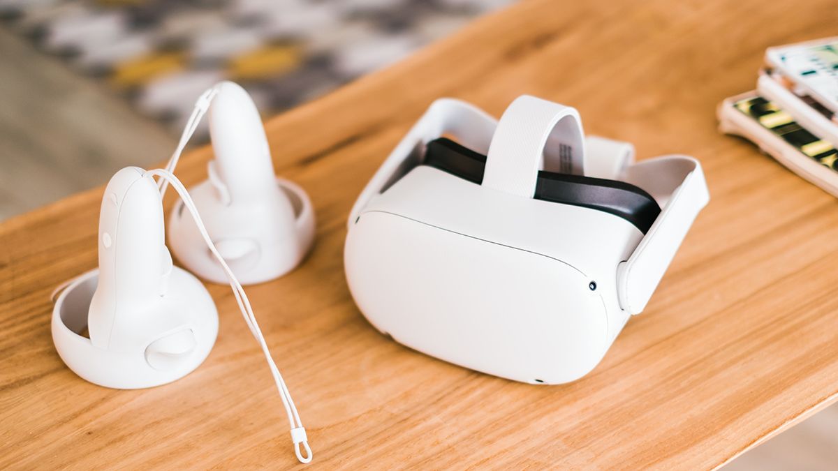 A Meta Quest 2 VR headset and controllers on a living room table.