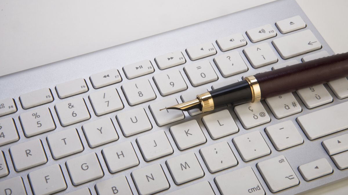 An fountain pen on a computer keyboard.