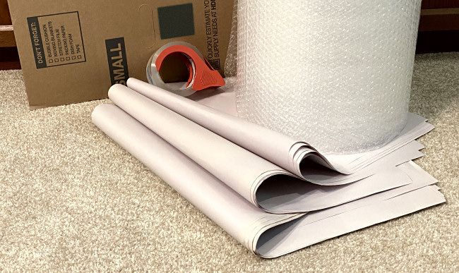 The packing materials you'll need: A cardboard box, newsprint, bubble wrap, and packing tape.