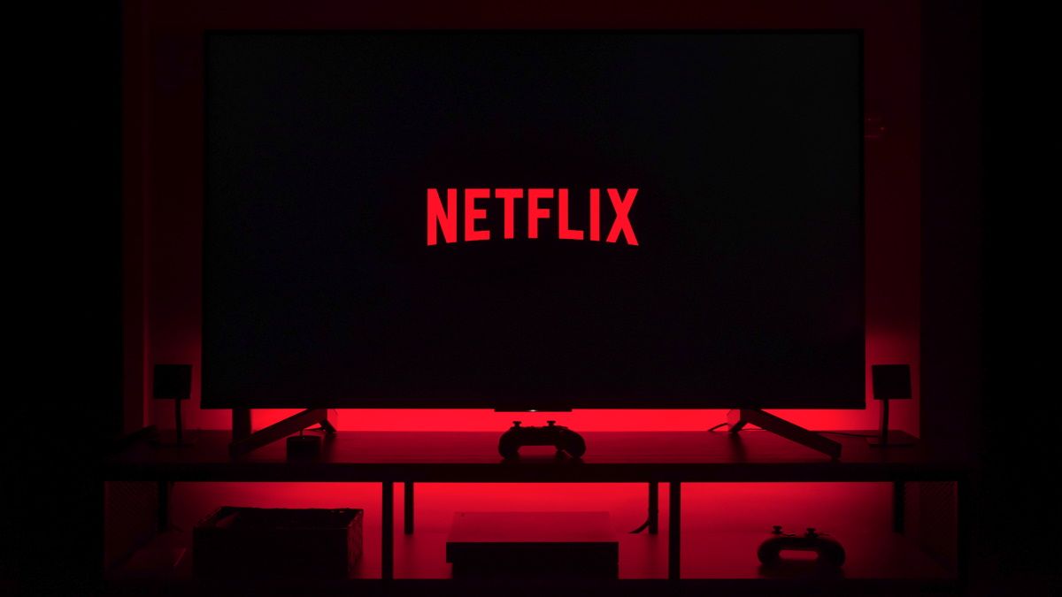 The Netflix logo on a TV in a dark room.