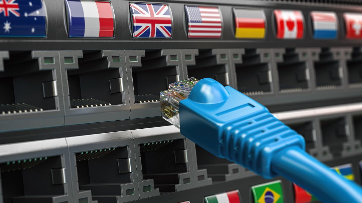 Plugging an Ethernet cable into ports labelled with different countries' flags.