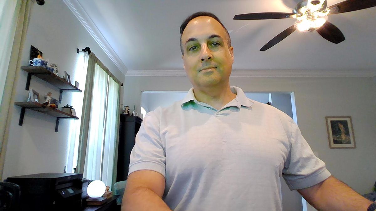 Webcam image from Lenovo ThinkPad Z13 Gen 1 Touchscreen Notebook showing a man in a collared short sleeve shirt