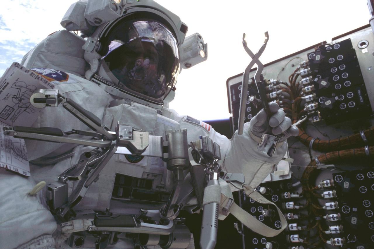 Photo of an astronaut repairing the Hubble in space