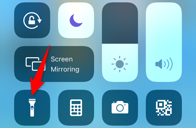 Select the flashlight icon in Control Center.
