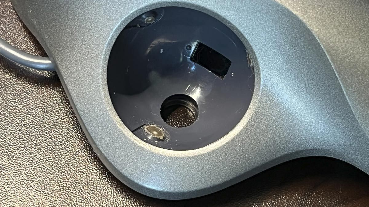 The inside of a trackball mouse, showing dirt build up.