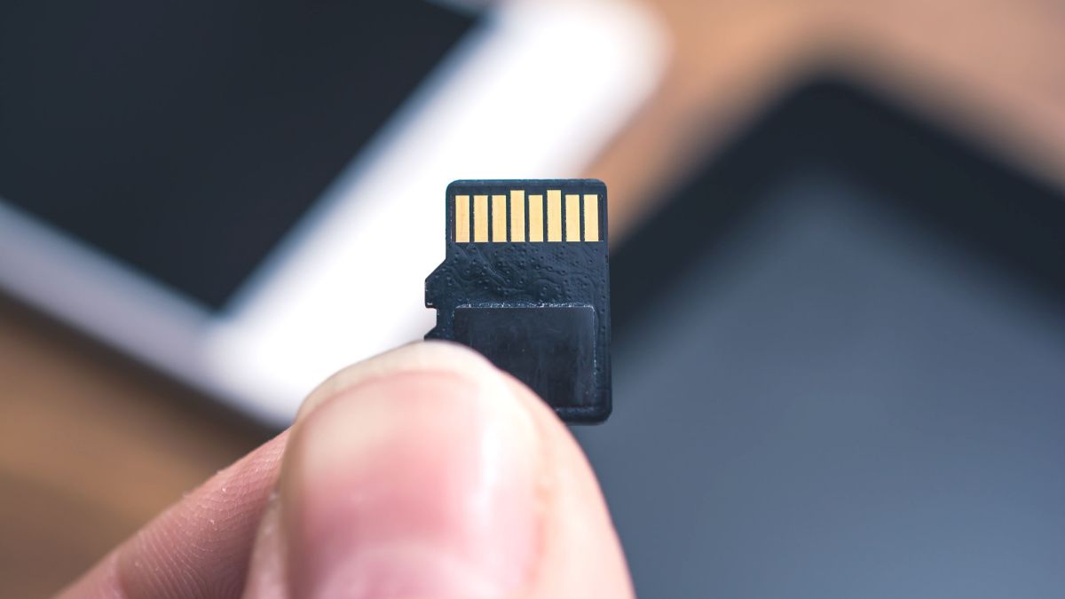 MicroSD card in someone's hand.