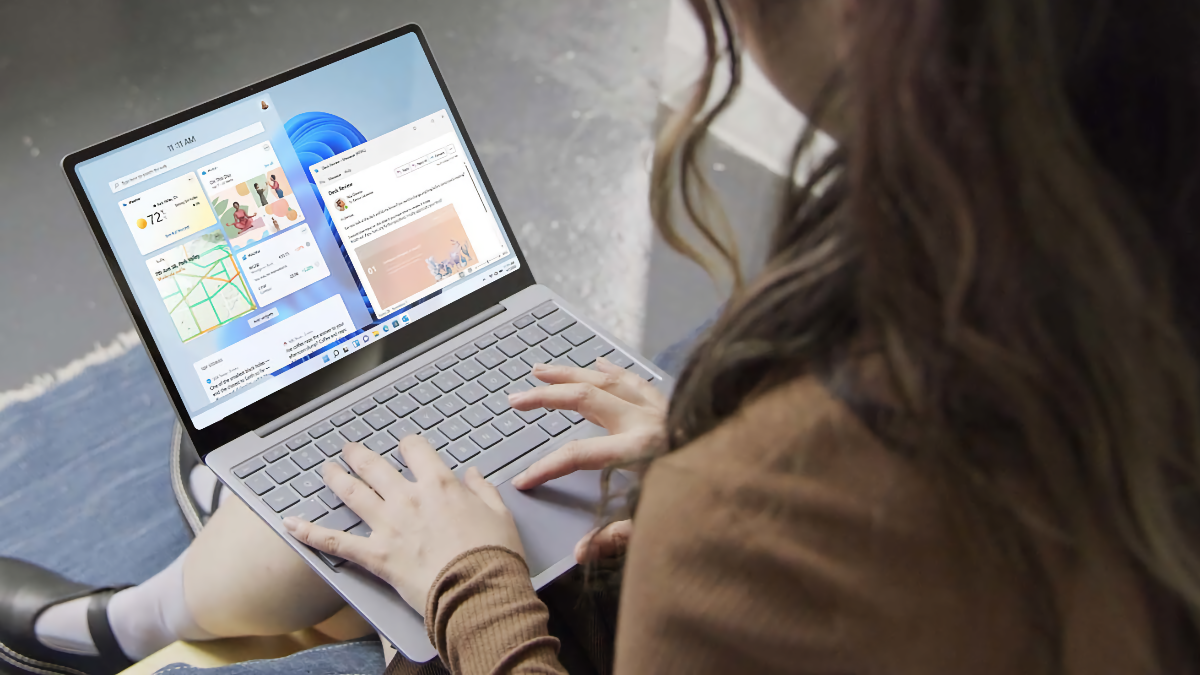 Girl typing on a Microsoft Surface Laptop Go 2