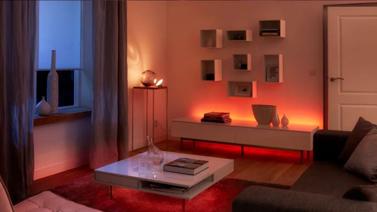 A living room with Hue smart lights illuminating it in the evening.