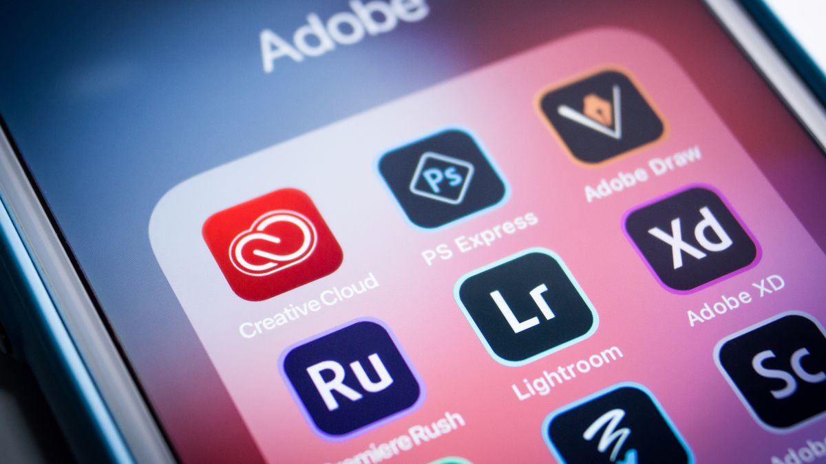 Several Adobe Creative Cloud app icons on an iPhone display.