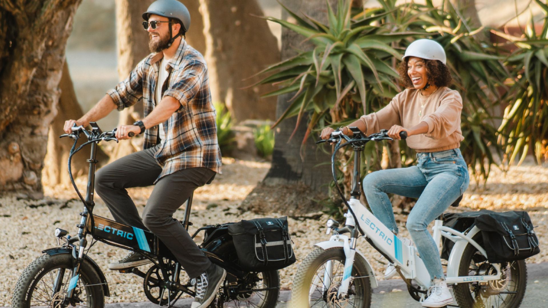 man and woman riding electric bikes