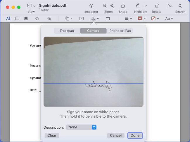 Paper held up to a Mac camera for a signature
