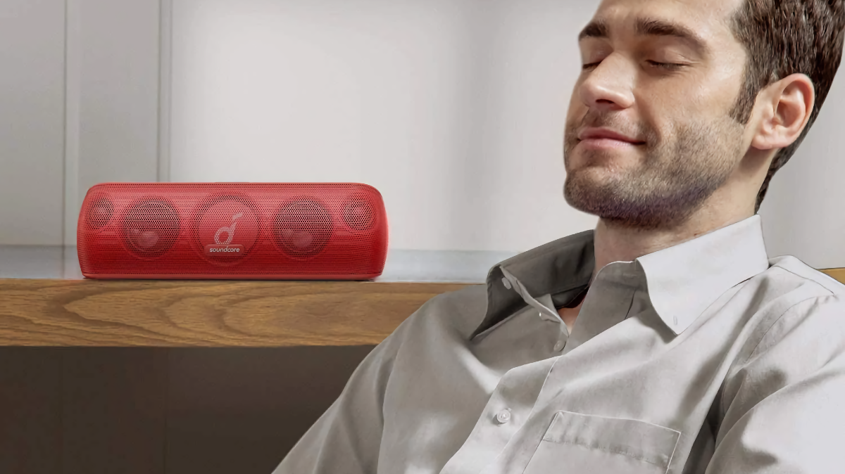 Soundcore Motion+ Bluetooth Speaker 2 sitting on a shelf while man listens to music