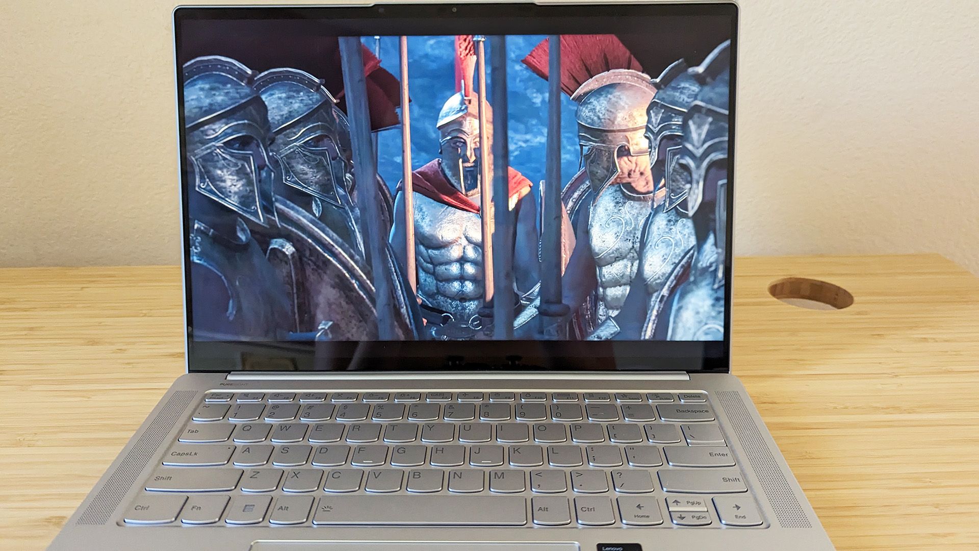 The Lenovo Slim 7i Pro X laptop with a game graphic on screen.