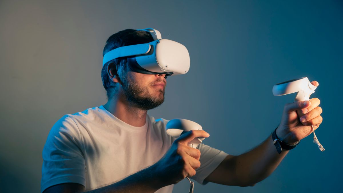 Man wearing a virtual reality headset and holding controllers.