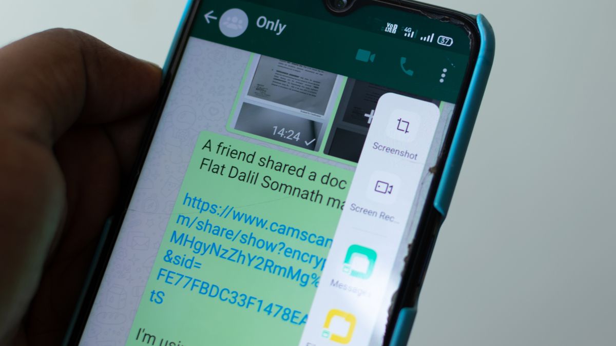 Closeup of a smartphone with a message containing a link on screen.