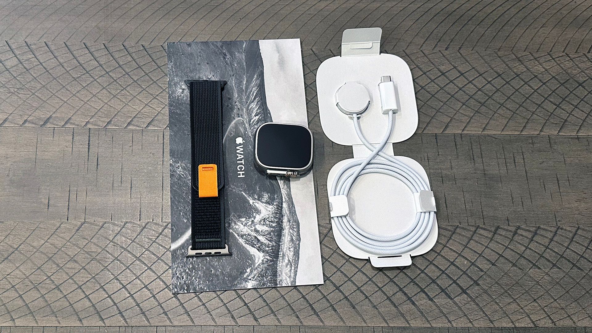 Apple Watch Ultra box contents spread out on table