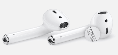A pair of AirPods with the serial number magnified.