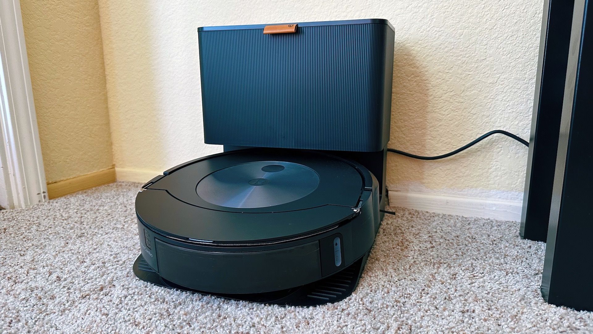 Roomba j7+ vacuum sitting in its docking station